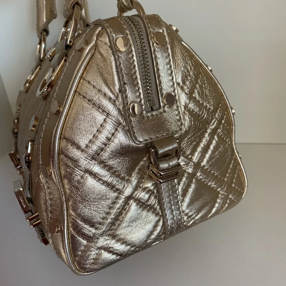 Hold Versace gold quilted handbag